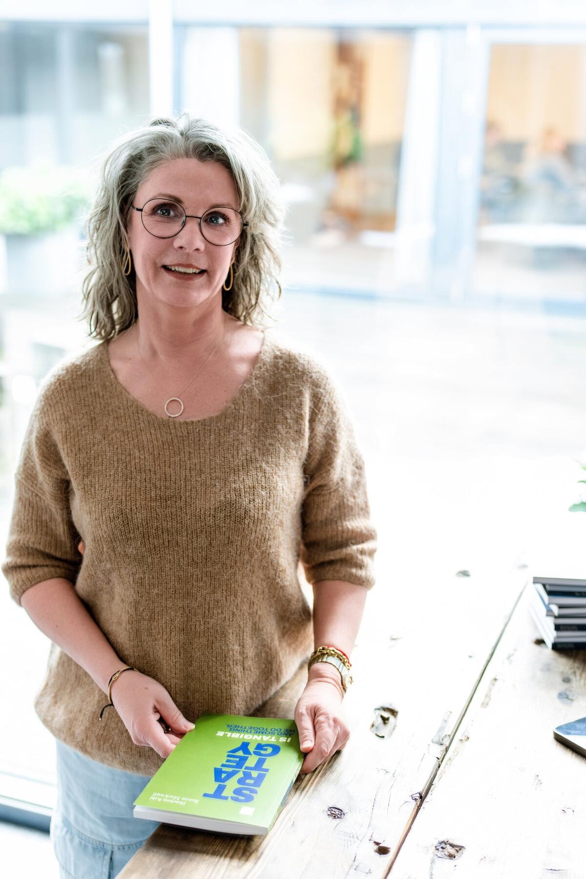 Sanne Markwall, author of Strategy is Tangible, standing confidently in a black blazer